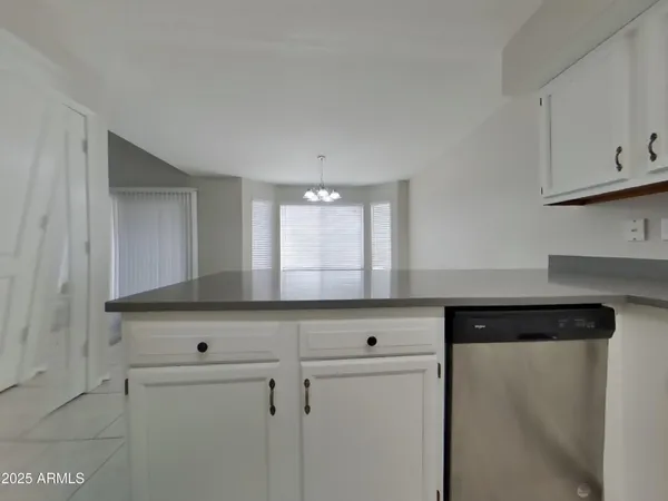 a kitchen with white cabinets