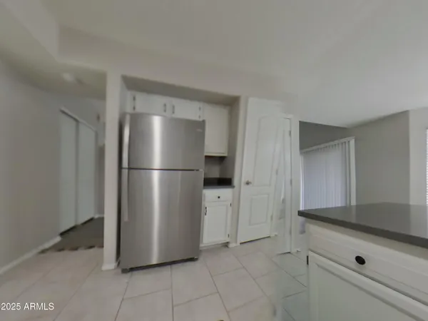 a kitchen with a refrigerator and cabinets