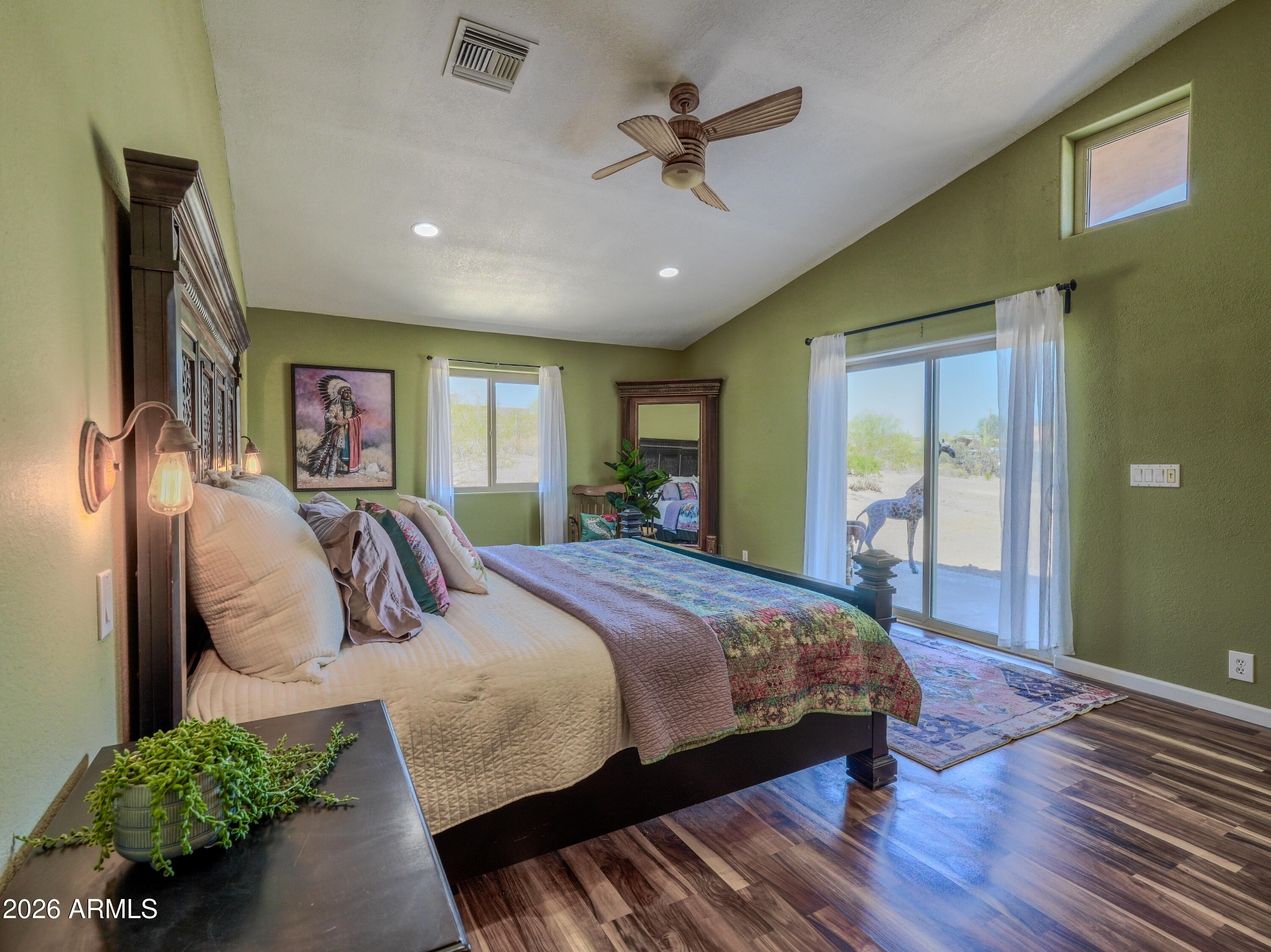 1224 North Acacia Road Apache Junction, AZ 85119 - Photo 19 of 48 a bedroom with a large bed chandelier and a window