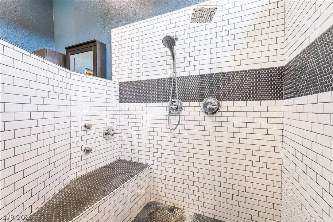 261 Timber Hollow Street Henderson, NV 89012 - Photo 34 of 51 Indulge in a rejuvenating experience within this generously sized shower, featuring dual showerheads.