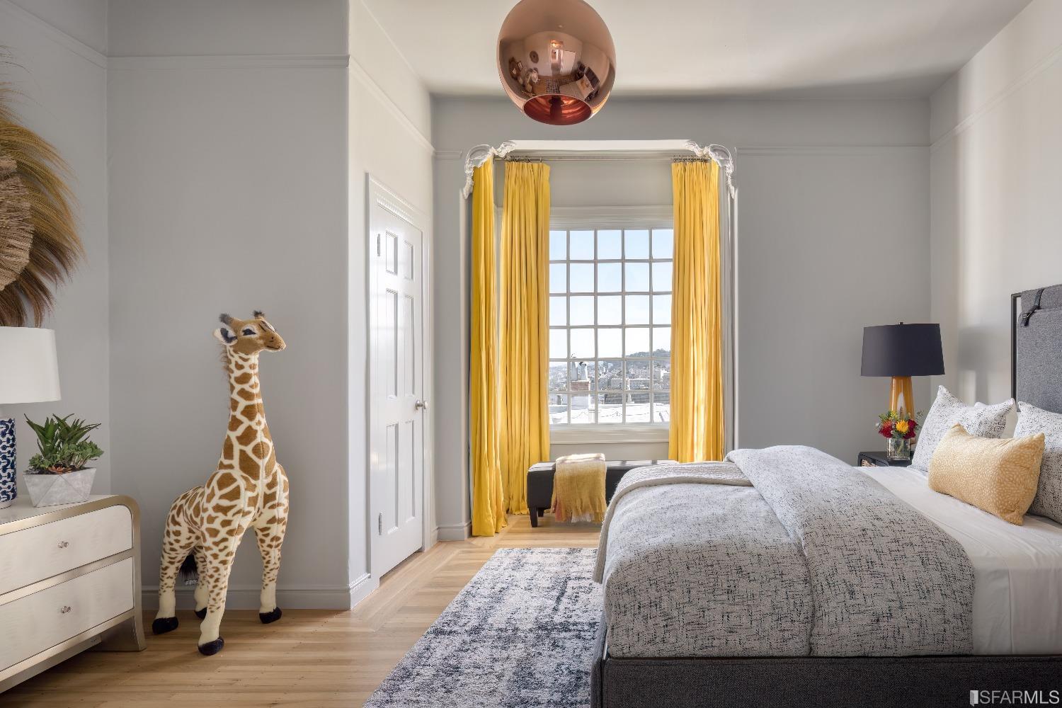 3007 Jackson Street San Francisco, CA 94115 - Photo 15 of 30 a bedroom with a bed and a chandelier