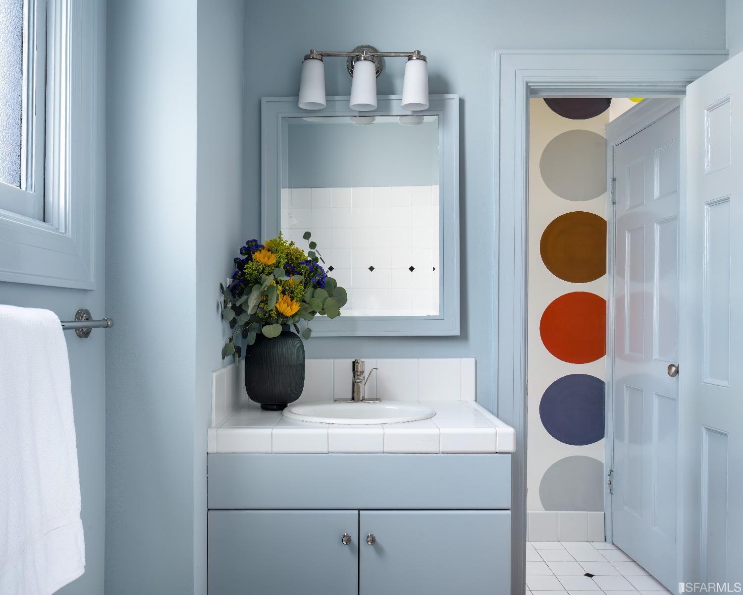 3007 Jackson Street San Francisco, CA 94115 - Photo 18 of 30 a bathroom with a sink and a mirror
