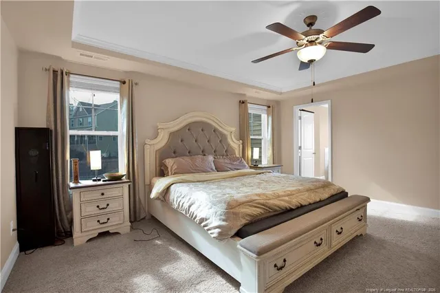a bedroom with a bed and a ceiling fan