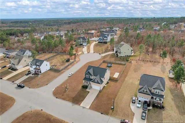 an aerial view of a house with a yard