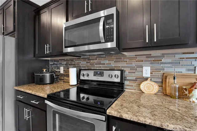 a kitchen with granite countertop stainless steel appliances and cabinets