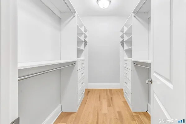 a view of walk in closet with empty racks