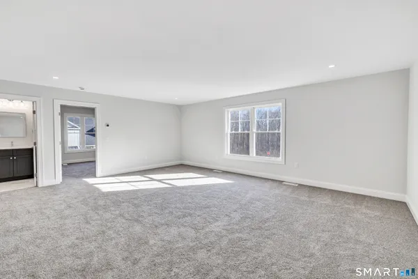 an empty room with a empty space and windows