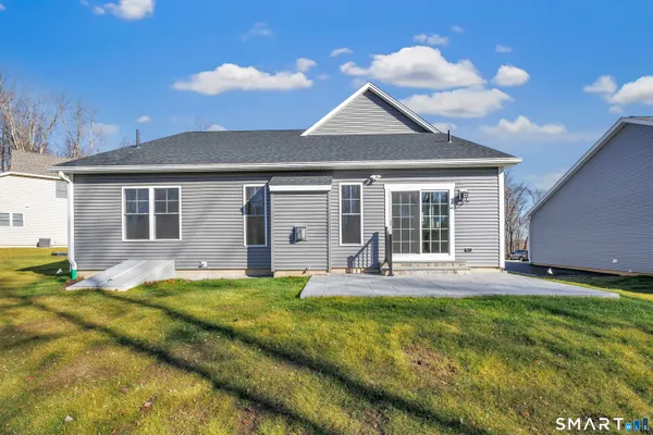 a front view of a house with a yard and porch