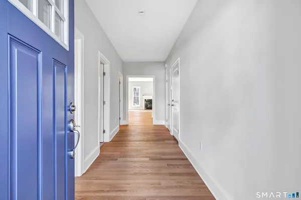 a view of a hallway with wooden floor