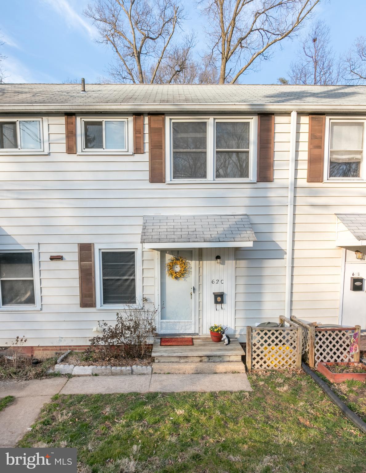 62 Ridge Road, Unit C Greenbelt, MD 20770 - Photo 1 of 9 a front view of a house with a yard