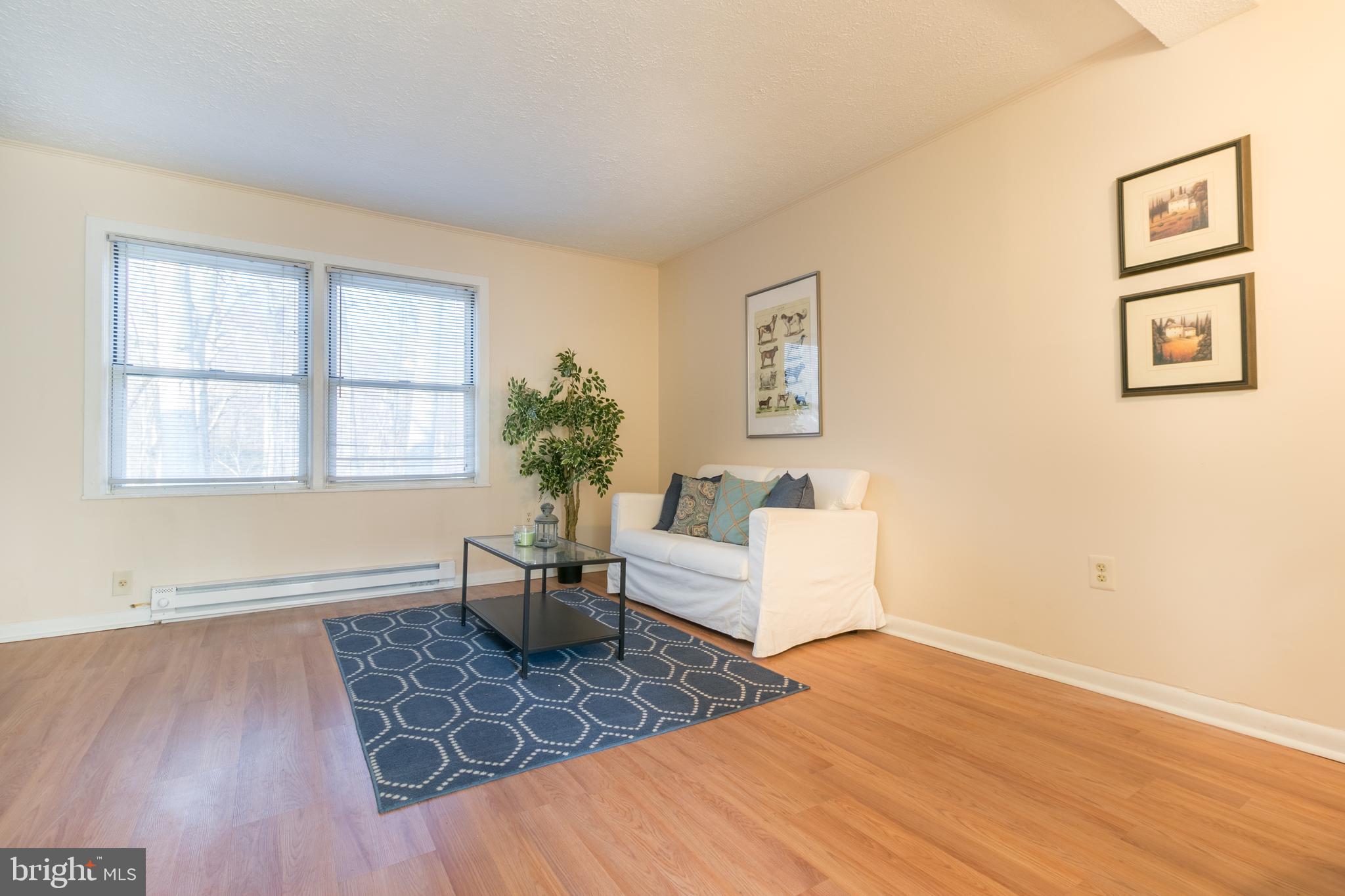 62 Ridge Road, Unit C Greenbelt, MD 20770 - Photo 3 of 9 a living room with furniture and a wooden floor