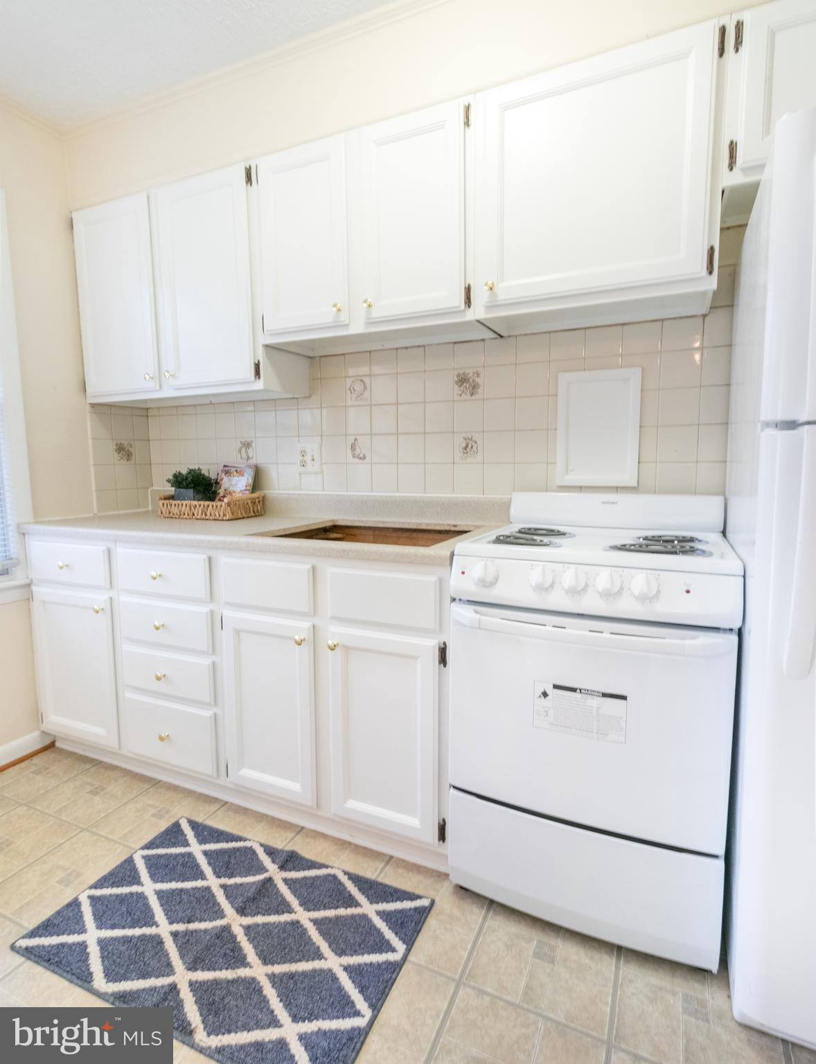 62 Ridge Road, Unit C Greenbelt, MD 20770 - Photo 4 of 9 a kitchen with granite countertop white cabinets and appliances