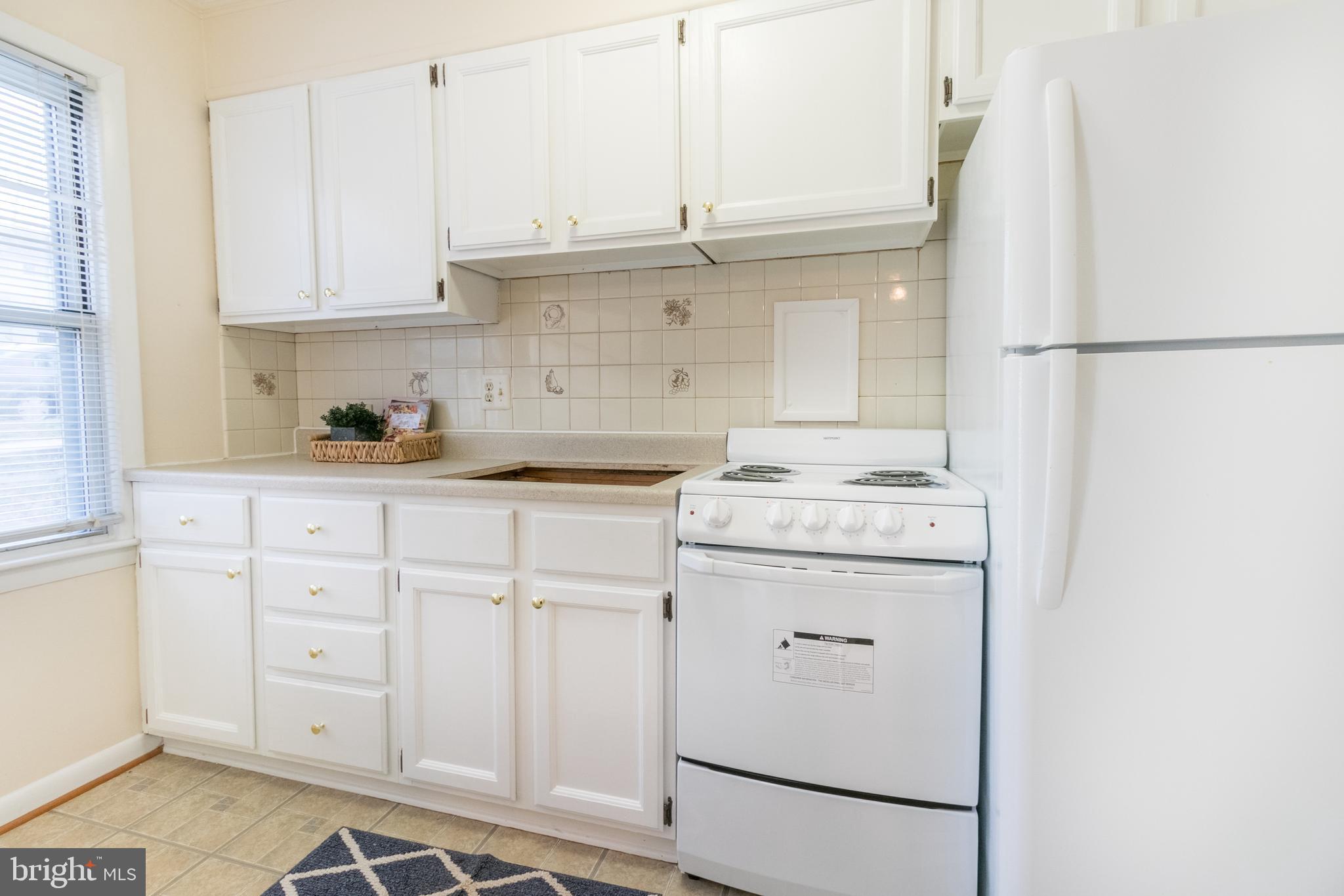 62 Ridge Road, Unit C Greenbelt, MD 20770 - Photo 5 of 9 a kitchen with appliances cabinets and a sink