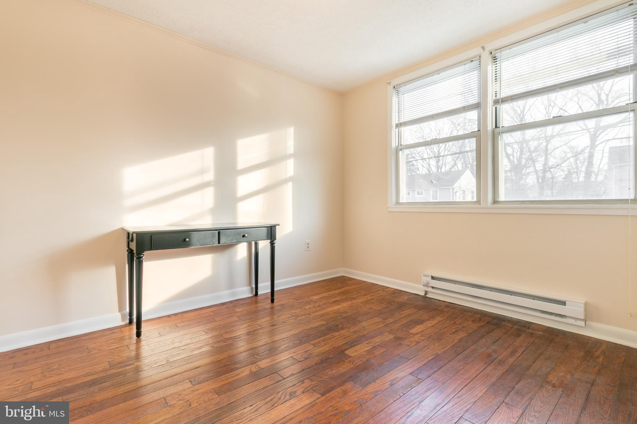 62 Ridge Road, Unit C Greenbelt, MD 20770 - Photo 6 of 9 an empty room with wooden floor and windows