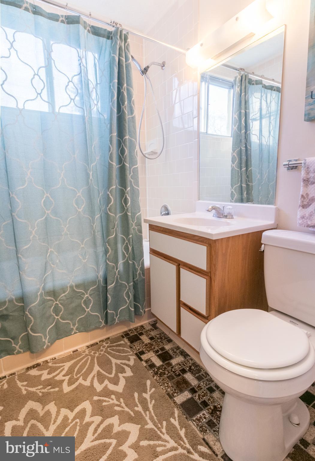 62 Ridge Road, Unit C Greenbelt, MD 20770 - Photo 8 of 9 a bathroom with a sink toilet and shower