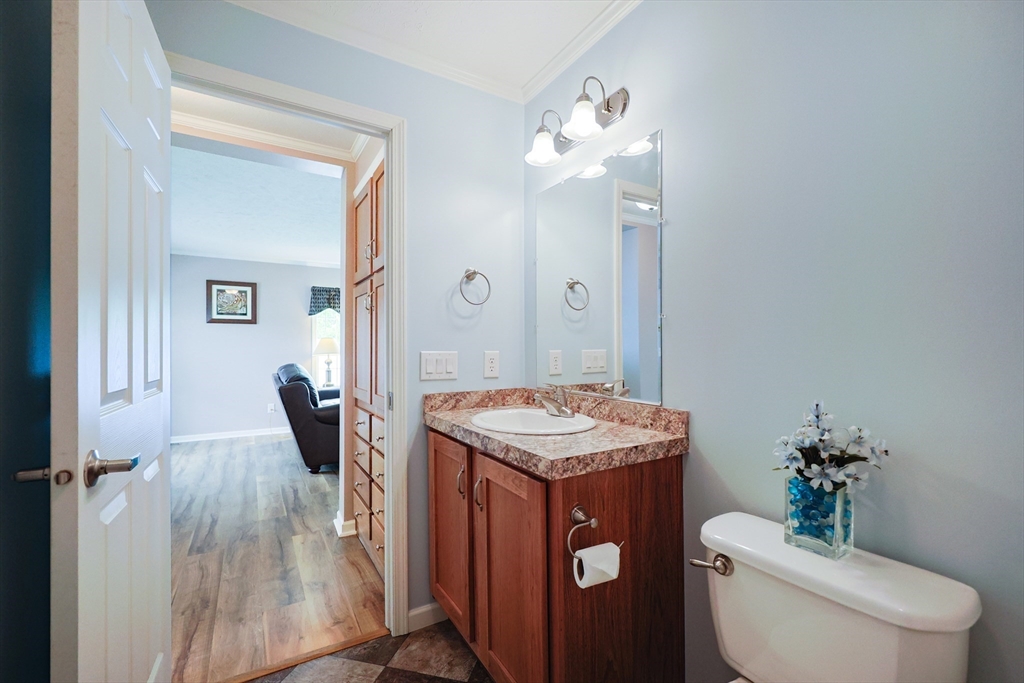 12 Linsay Drive Raynham, MA 02767 - Photo 16 of 28 a bathroom with a granite countertop sink toilet and mirror