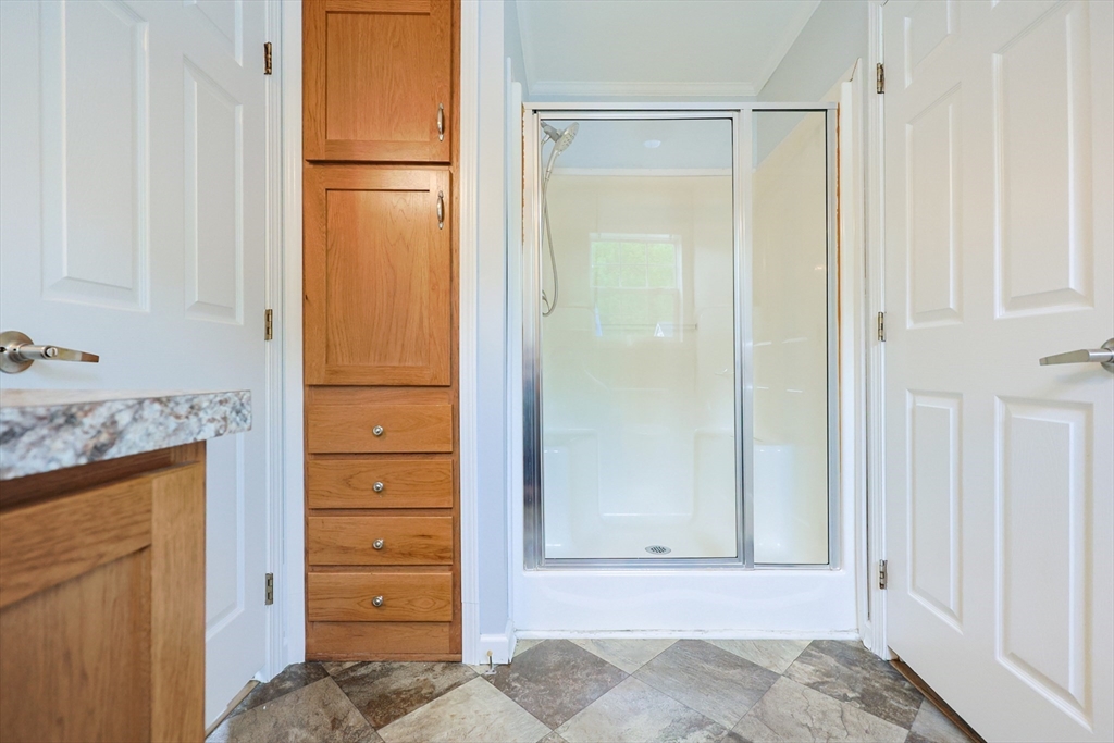 12 Linsay Drive Raynham, MA 02767 - Photo 19 of 28 a view of walk in closet with cabinet
