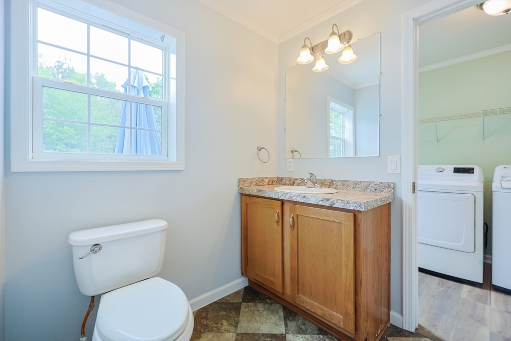 12 Linsay Drive Raynham, MA 02767 - Photo 20 of 28 a bathroom with a granite countertop toilet sink and mirror