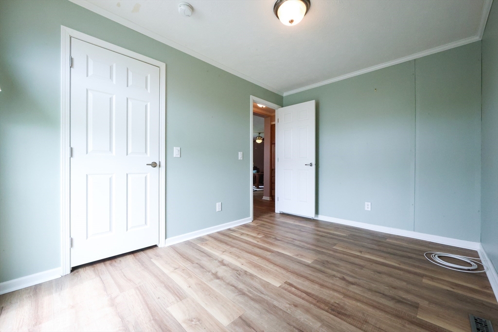 12 Linsay Drive Raynham, MA 02767 - Photo 22 of 28 a view of an empty room with wooden floor