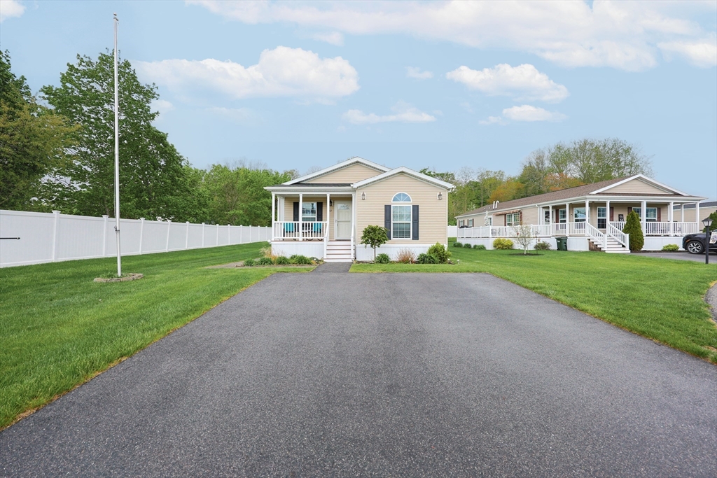 12 Linsay Drive Raynham, MA 02767 - Photo 3 of 28 a front view of a house with a garden and trees