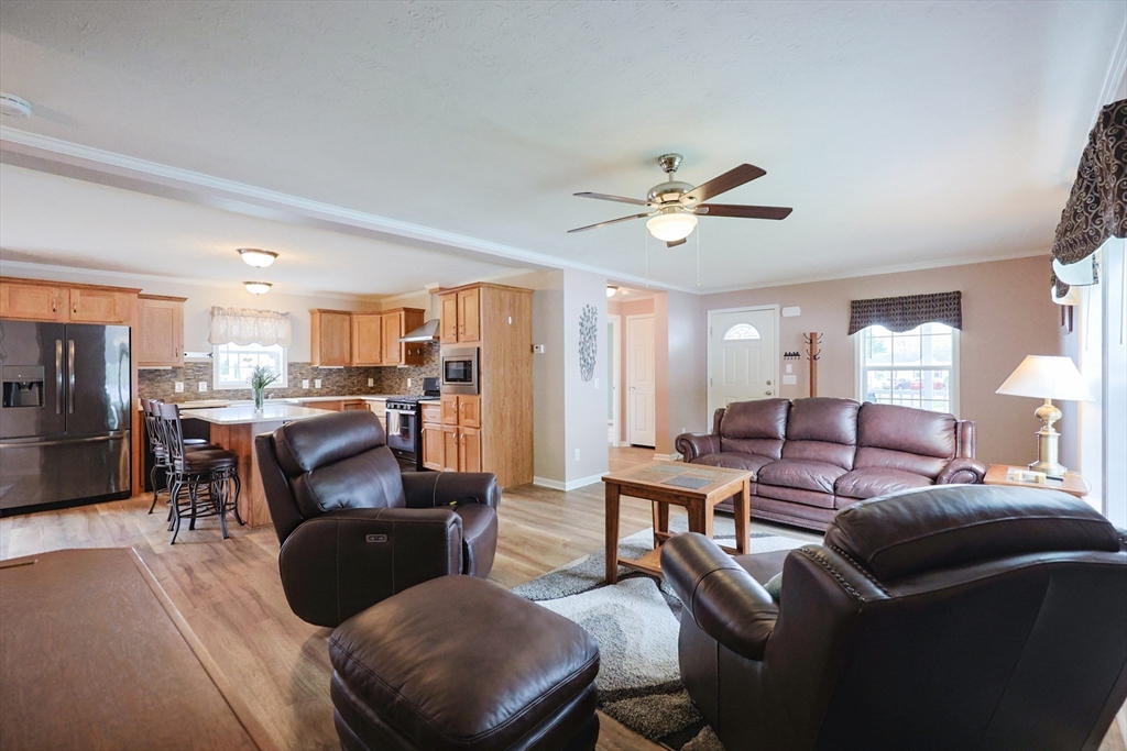 12 Linsay Drive Raynham, MA 02767 - Photo 5 of 28 a living room with furniture kitchen view and a chandelier
