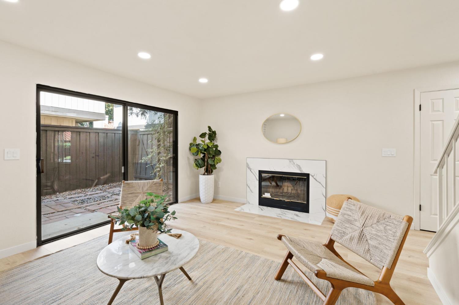 6856 Calvine Road Sacramento, CA 95823 - Photo 1 of 1 a living room with furniture a fireplace and a potted plant