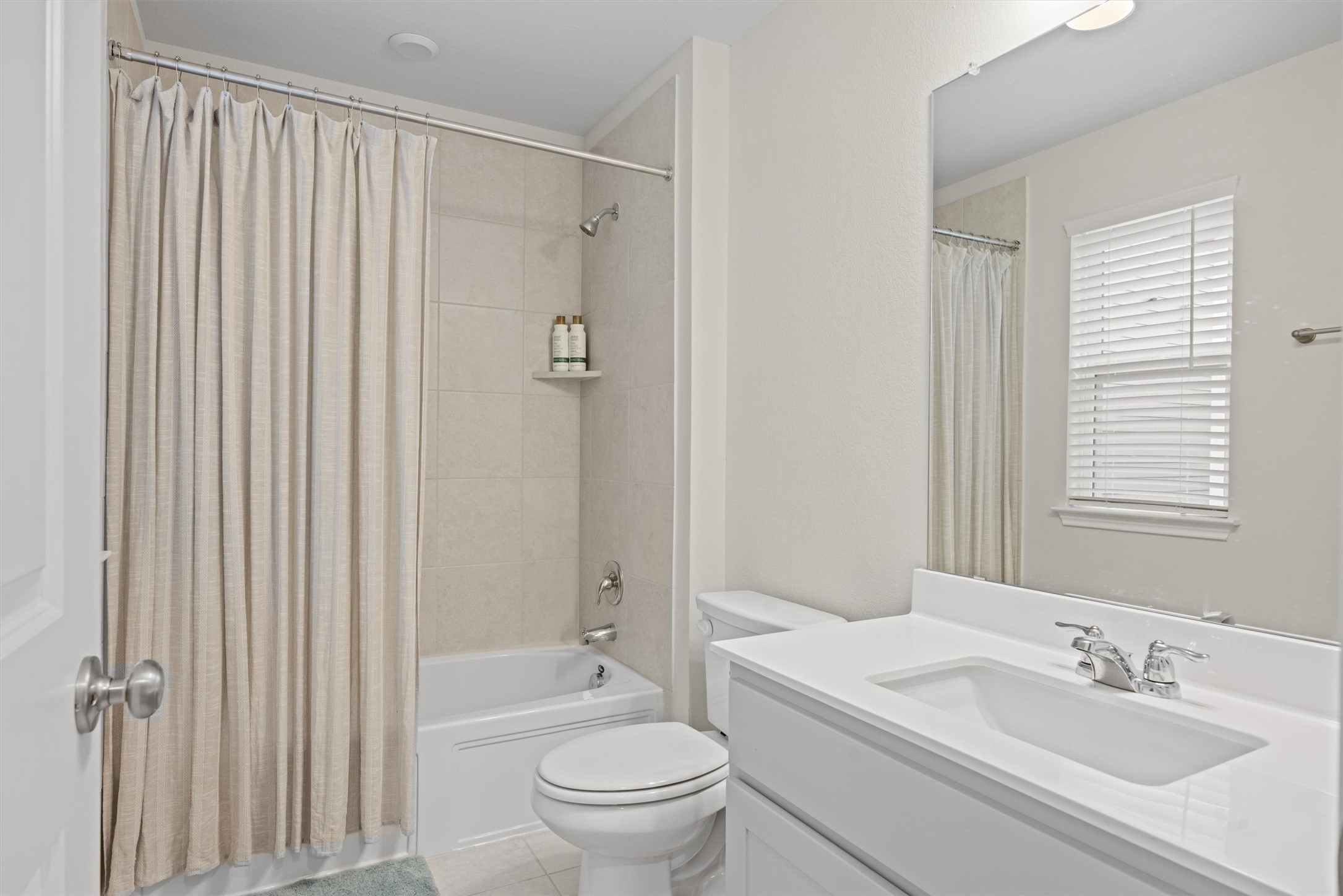 313 Toddy Way Leander, TX 78641 - Photo 35 of 39 Guest Flat full Bathroom with shower / bath combination with curtain, vanity, and light tile patterned floors