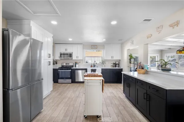 a kitchen with refrigerator a sink and cabinets