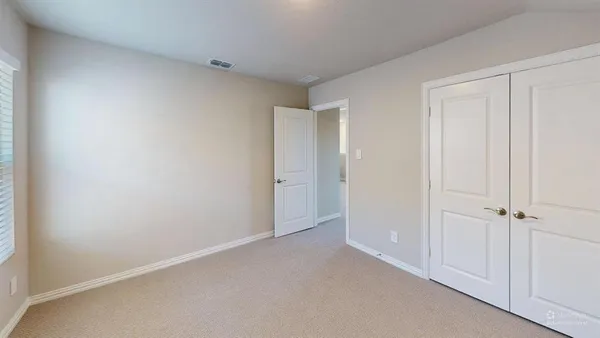 an empty room with closet area