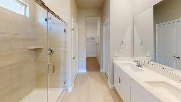 a spacious bathroom with a double vanity sink and mirror