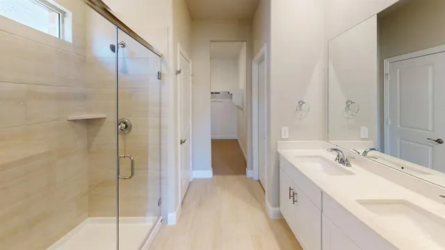 a spacious bathroom with a double vanity sink and mirror