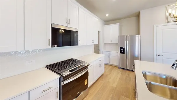 a kitchen with a stove and a refrigerator