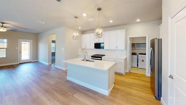 a kitchen with refrigerator and cabinets