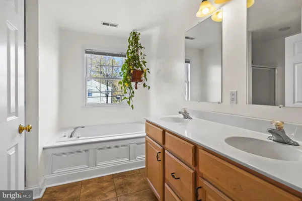 a view of a house with a big yard and large trees