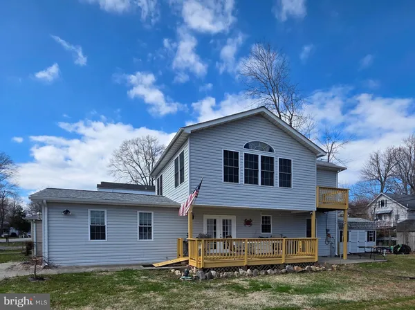 a sign broad in front of flowers