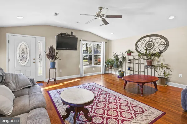 a bedroom with a bed and large windows