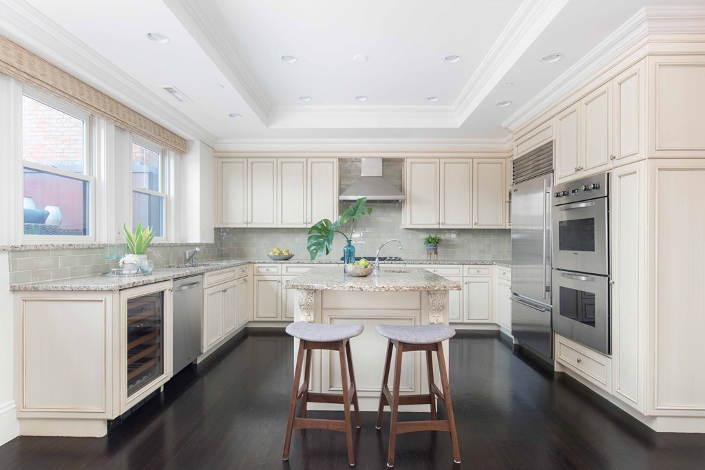 348 Beacon Street, Unit PH Boston, MA 02116 - Photo 11 of 34 a kitchen with granite countertop white cabinets and white appliances