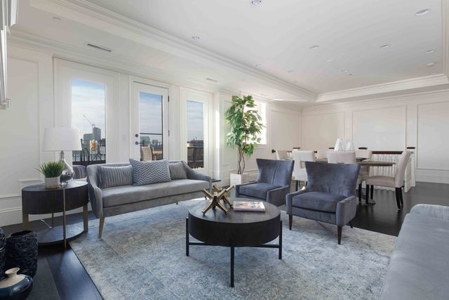 a living room with furniture potted plant and a window