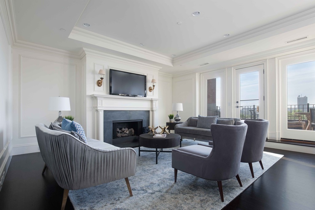 348 Beacon Street, Unit PH Boston, MA 02116 - Photo 15 of 34 a living room with furniture a flat screen tv and a fireplace