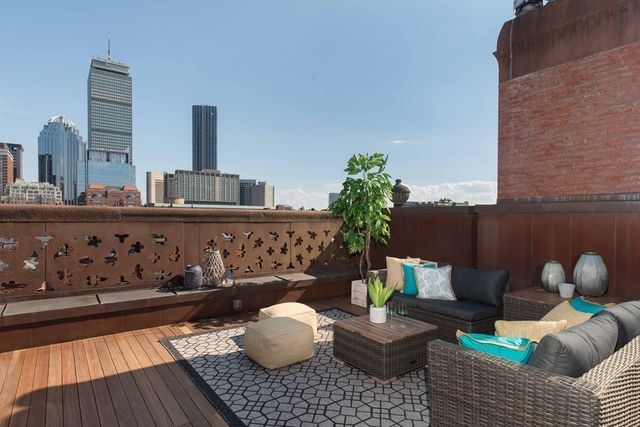 a living room with furniture and flowers