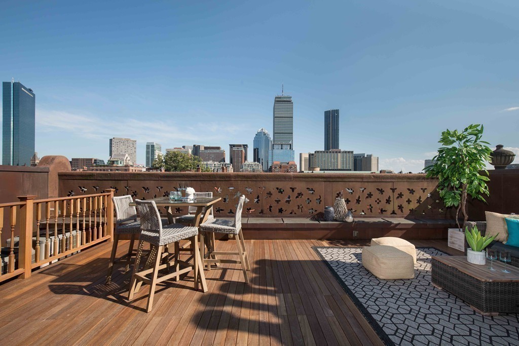 348 Beacon Street, Unit PH Boston, MA 02116 - Photo 30 of 34 a view of a balcony with dining table and chairs