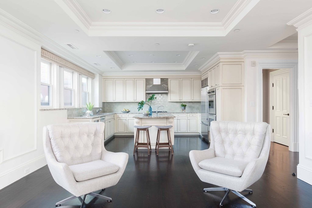 348 Beacon Street, Unit PH Boston, MA 02116 - Photo 9 of 34 a living room with couches a coffee table and chair with wooden floor