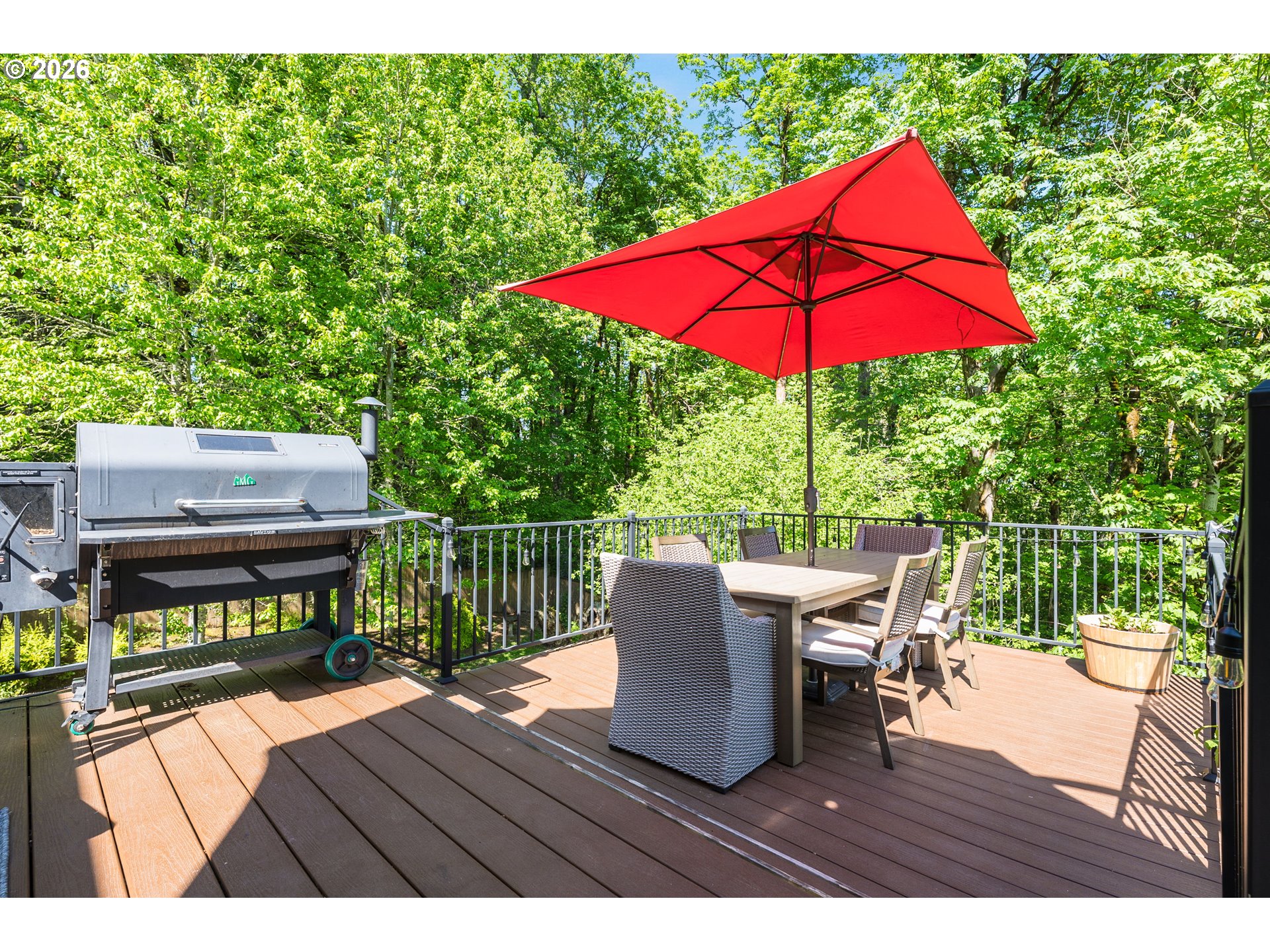 2097 Southwest Nancy Drive Gresham, OR 97080 - Photo 12 of 46 a view of a deck with a table and chairs under an umbrella