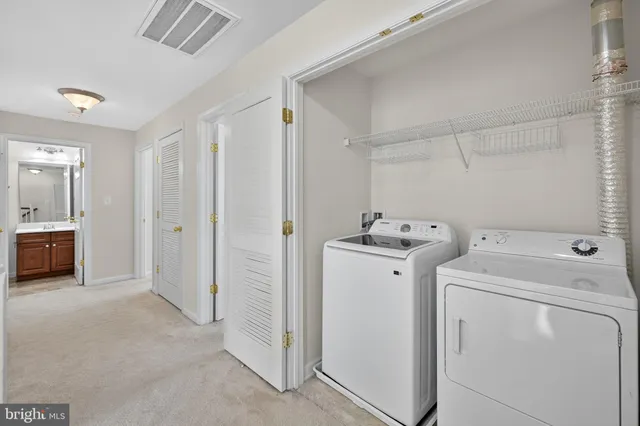 a view of a storage & utility room with dryer and washer