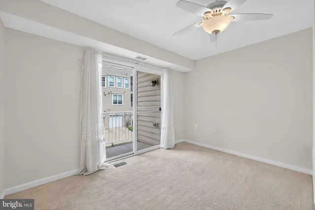 an empty room with chandelier fan