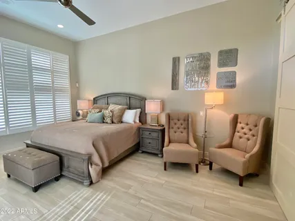 a bedroom with a bed and a couch