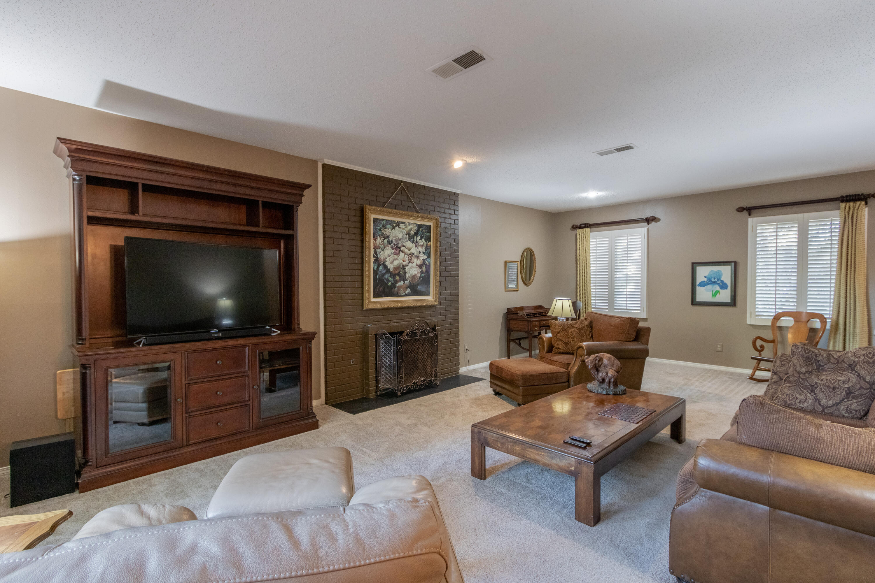 3722 63rd Drive Lubbock, TX 79413 - Photo 15 of 63 a living room with furniture and a flat screen tv