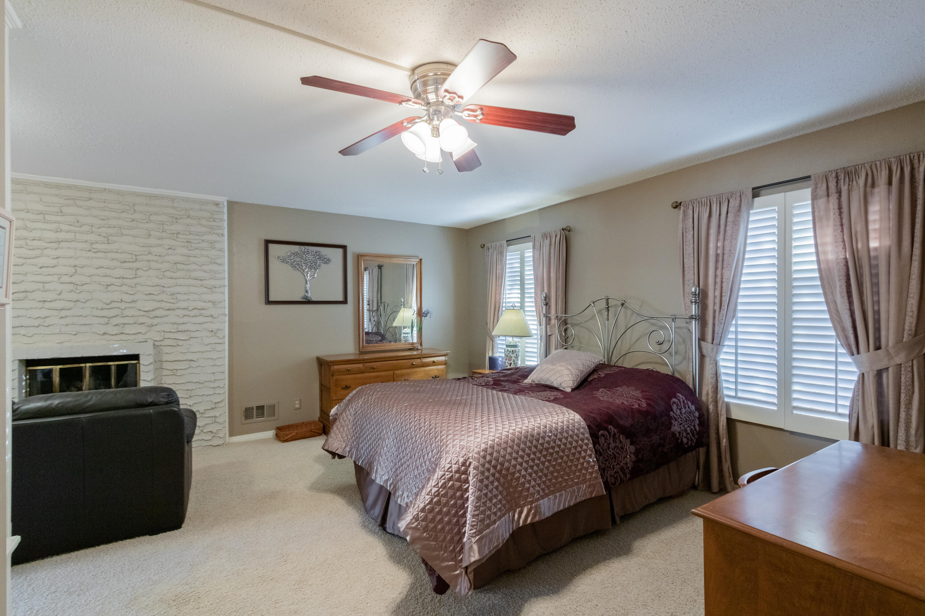 3722 63rd Drive Lubbock, TX 79413 - Photo 27 of 63 a bedroom with a bed and a chandelier