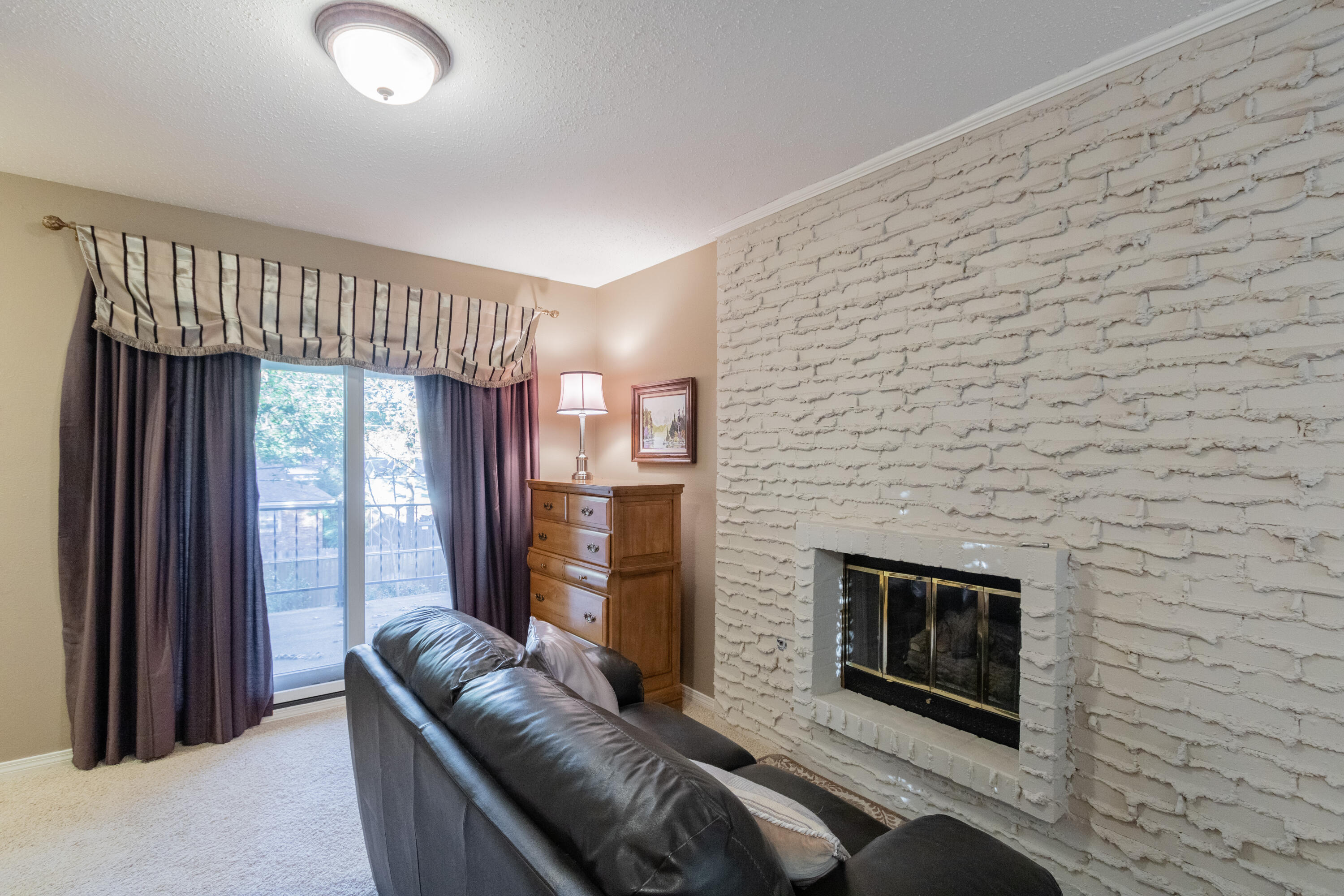3722 63rd Drive Lubbock, TX 79413 - Photo 30 of 63 a living room with furniture and a fireplace