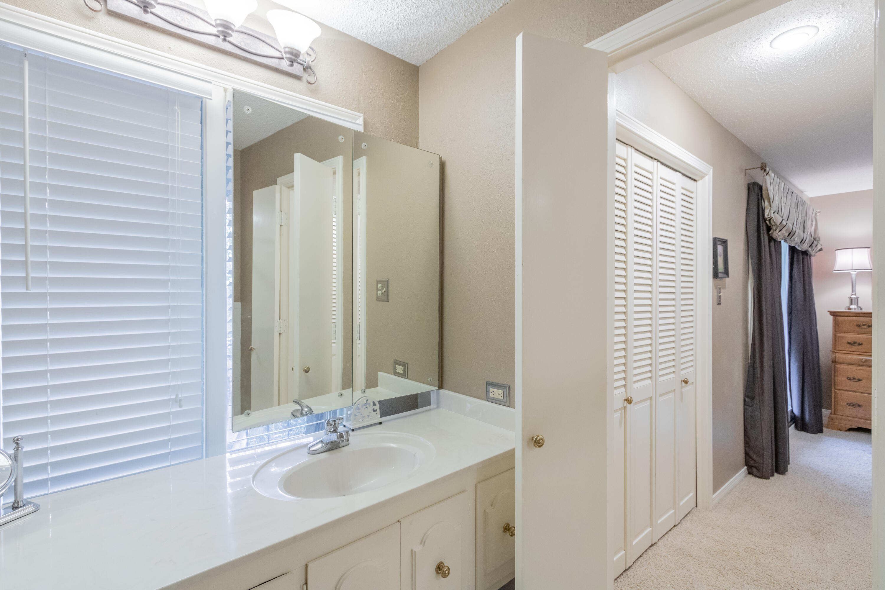 3722 63rd Drive Lubbock, TX 79413 - Photo 34 of 63 a bathroom with a sink and a mirror